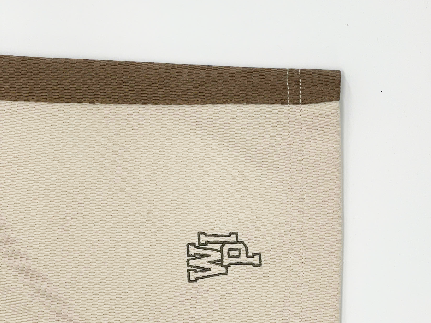 The “WIP” text is embroidered using flat embroidery technology