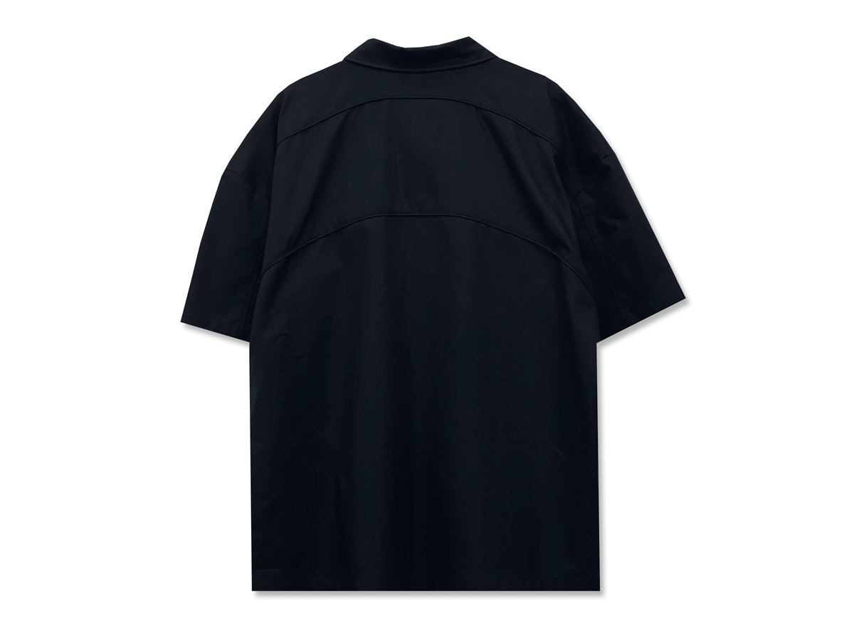 The back continues the curved seam design seen on the front, dividing the fabric into subtle panels. 