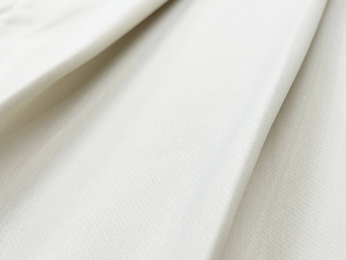 The pleats are evenly cut and carefully stitched, adding a subtle volume that flatters the figure while exuding a soft, feminine appeal.