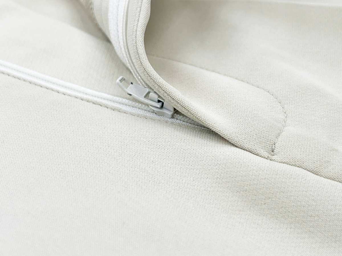 The zipper is expertly sewn and color-coordinated with the fabric, ensuring a seamless, refined look. 