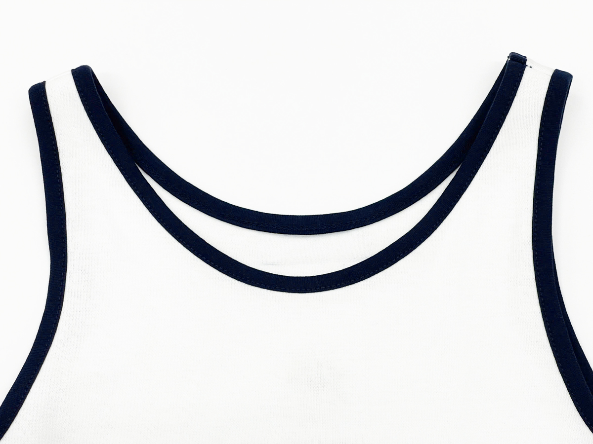 Moderately deep round neckline enhances the collarbone, with contrasting trim for a modern, edgy touch.