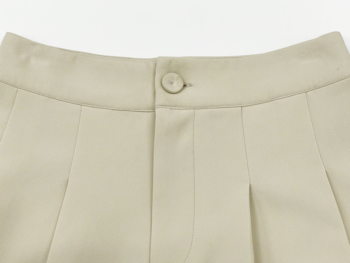 The waistband is wide and fastens with a front button, providing a snug, flattering fit at the waist.