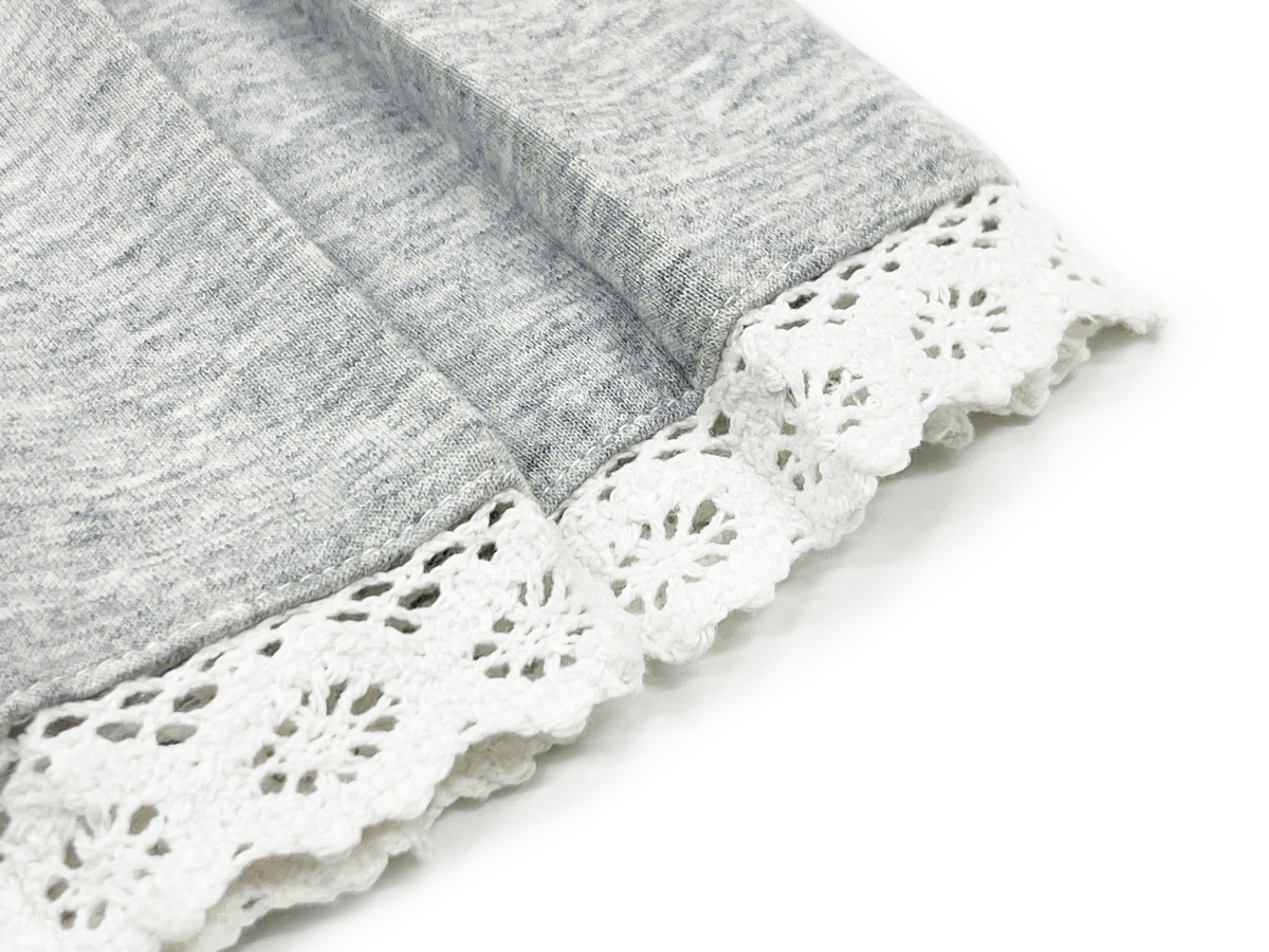 The lace trim is carefully selected and expertly stitched, adding a subtle yet elegant accent to the skirt. 