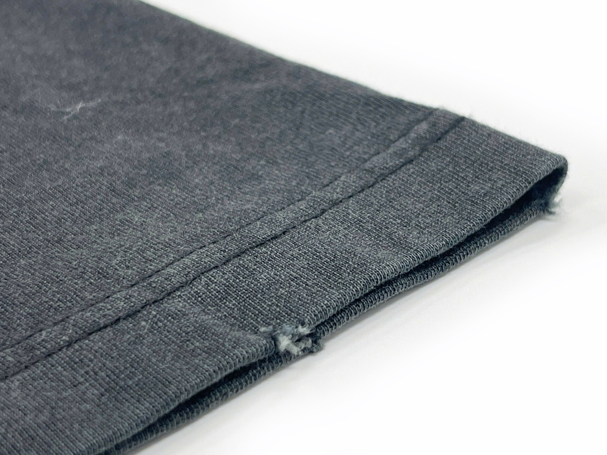 The sleeve cuffs feature a distressed effect, adding a rugged and edgy streetwear vibe. 