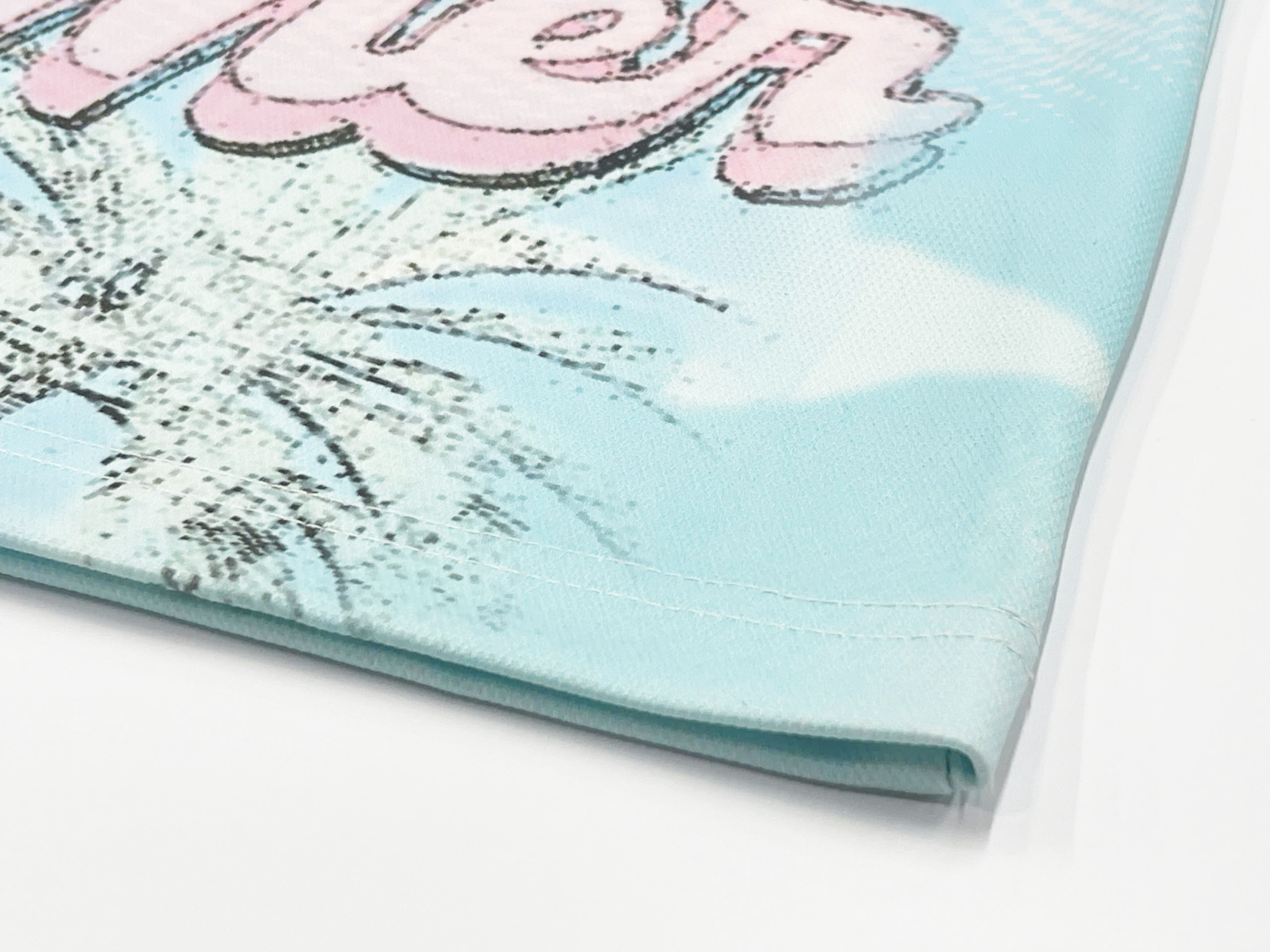 This pastel tee features a hand-drawn graffiti-style print on the back, giving off a bold yet laid-back vibe.